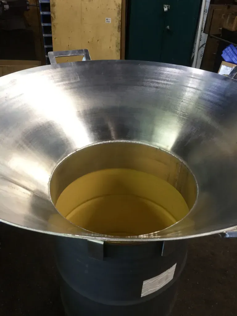 A metal barrel with a hole in the middle of it.