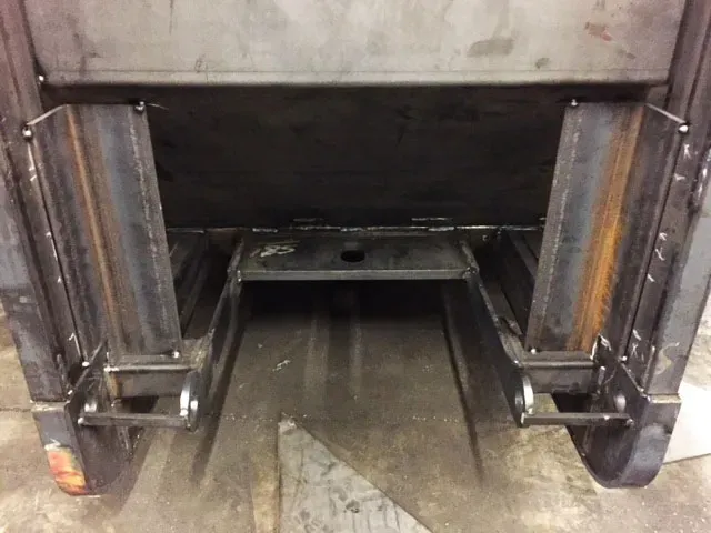 A close up of a metal structure with wheels on it.