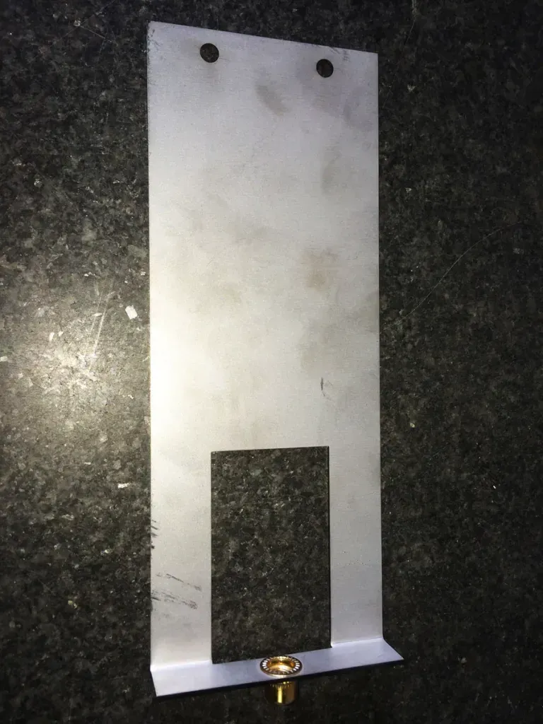 A piece of metal is sitting on a black surface