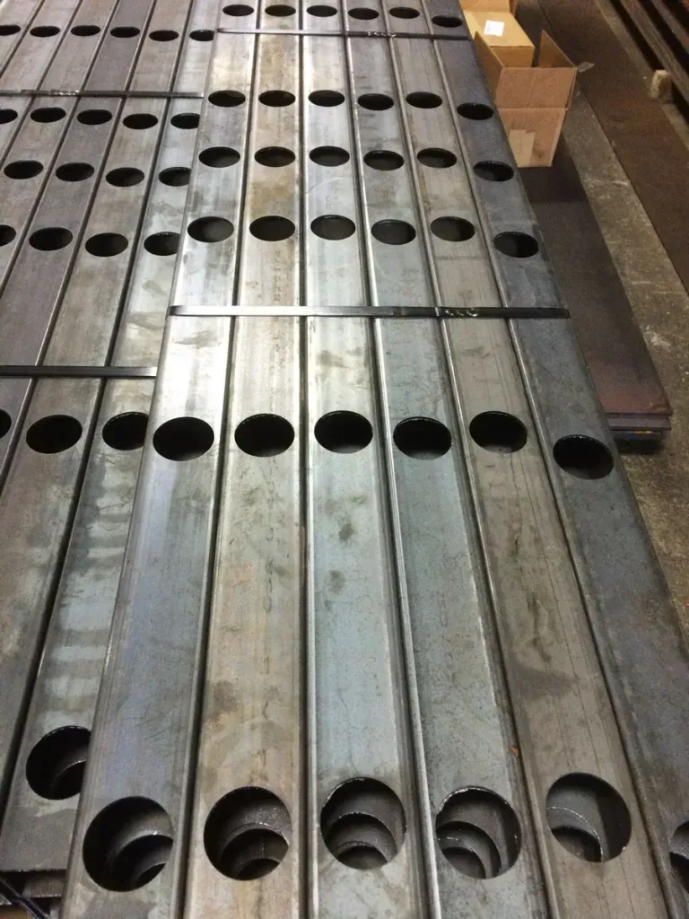 A bunch of metal bars with holes in them