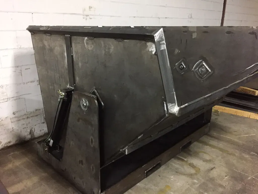 A large metal container is sitting on top of a pallet.