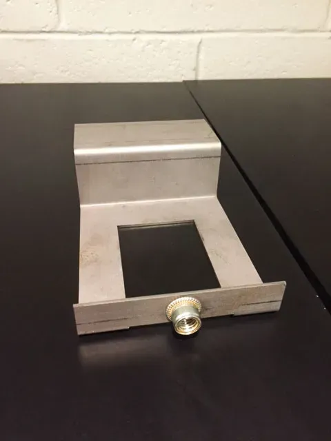 A piece of metal with a hole in the middle sits on a table