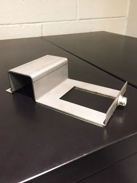A metal object is sitting on top of a black table