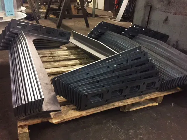 A pile of metal pieces on a wooden pallet