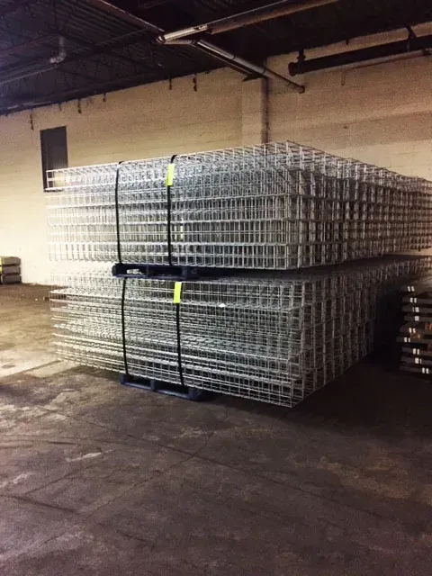A warehouse filled with lots of wire crates stacked on top of each other