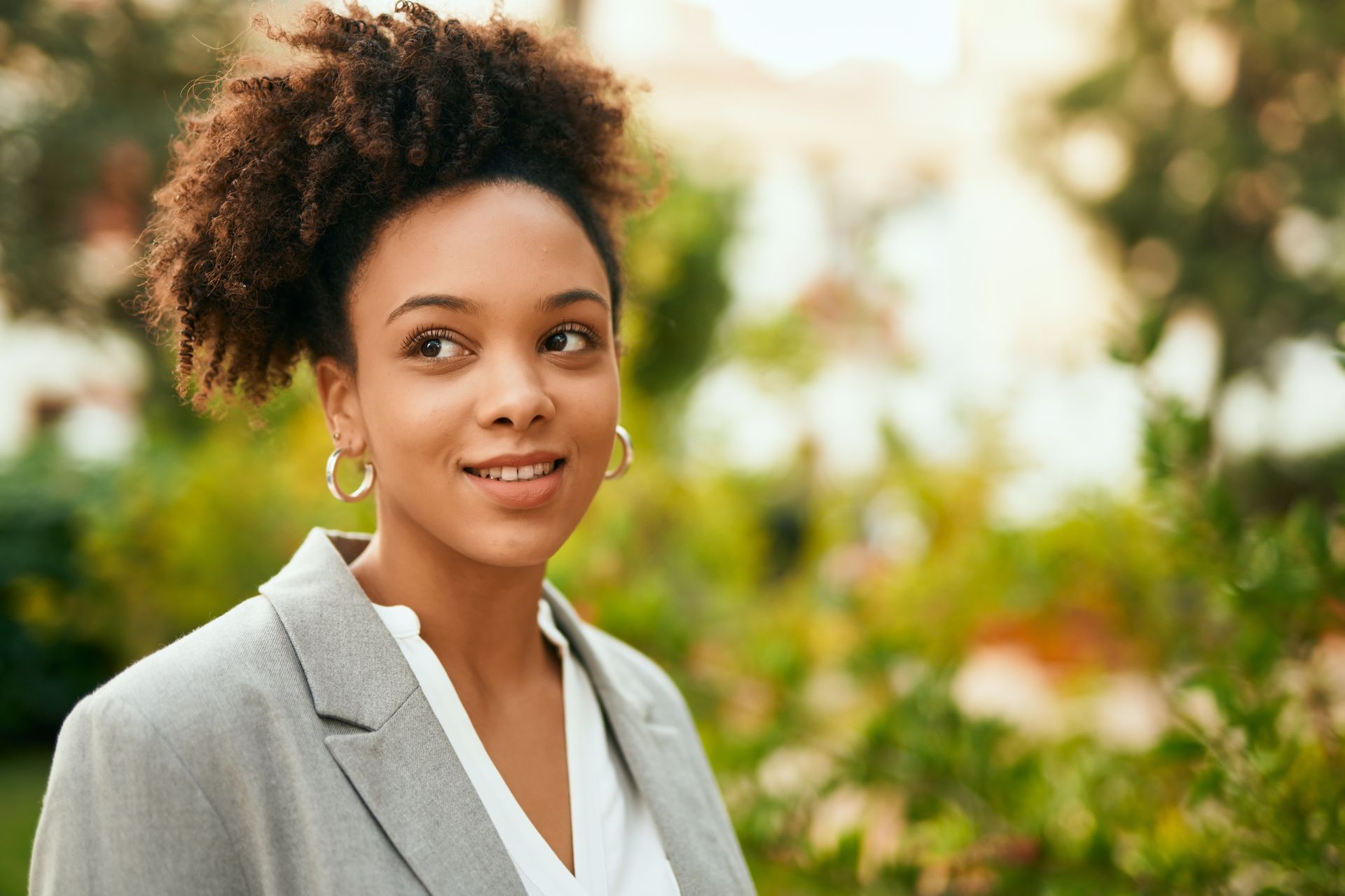 Sunset over a swamp, silhouetting trees in the water; orange and yellow sky reflecting on the surface.