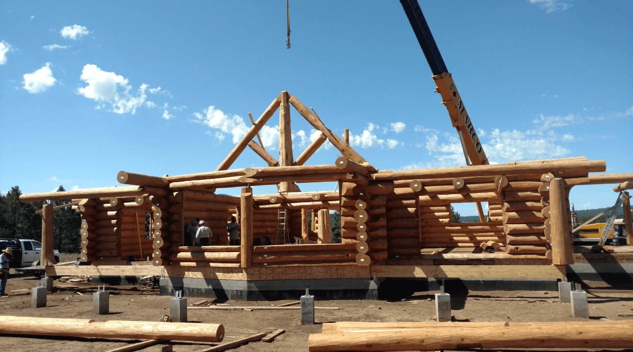 Log cabin with crane in clear sky|Flagstaff, AZ|Ag Builders
