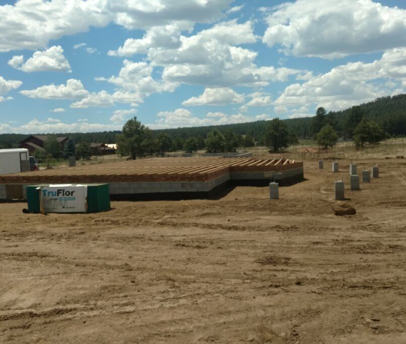 Log cabin with beautiful clouds|Flagstaff, AZ|Ag Builders