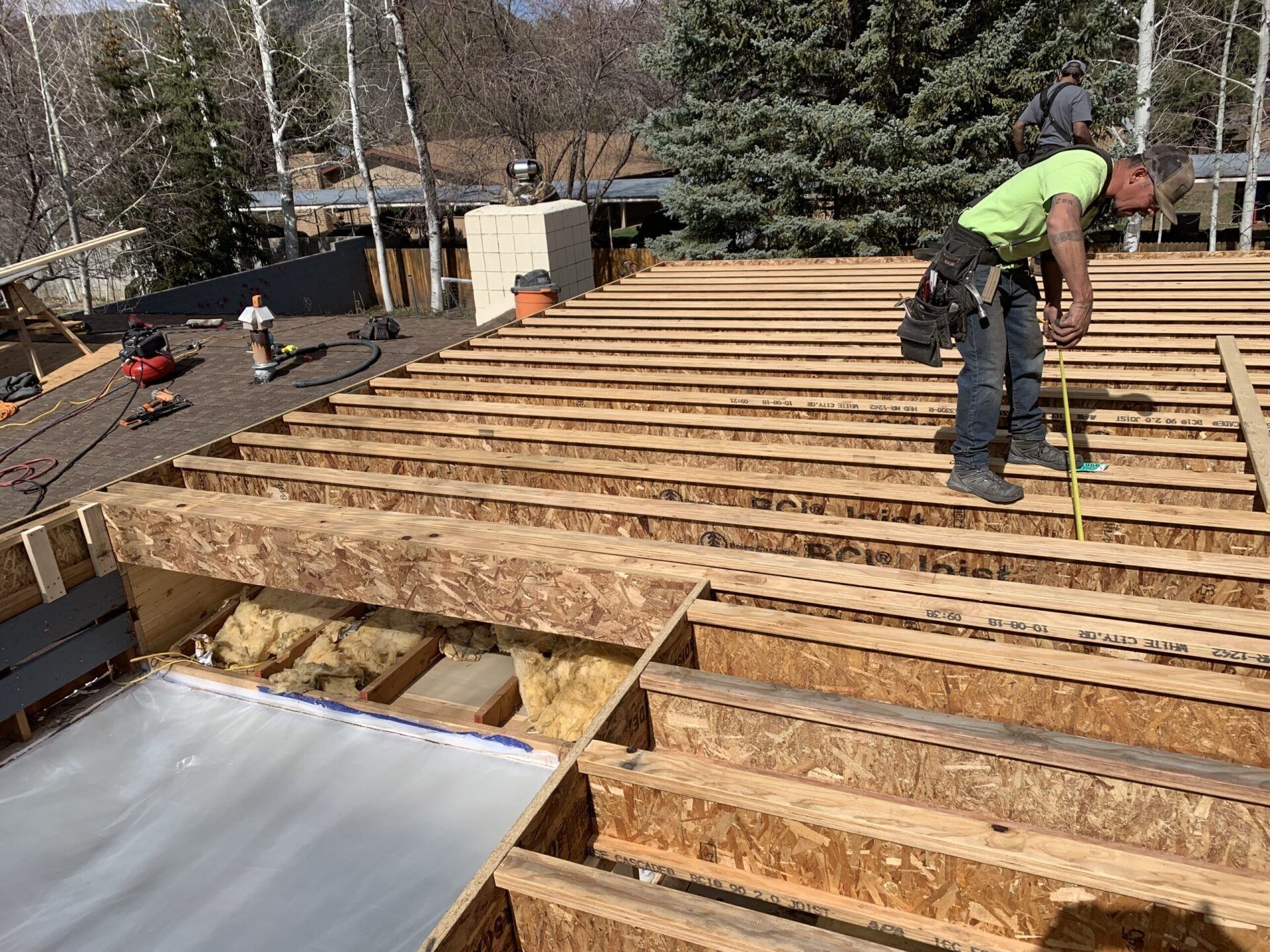 Worker measuring a roof|Flagstaff, AZ|Ag Builders