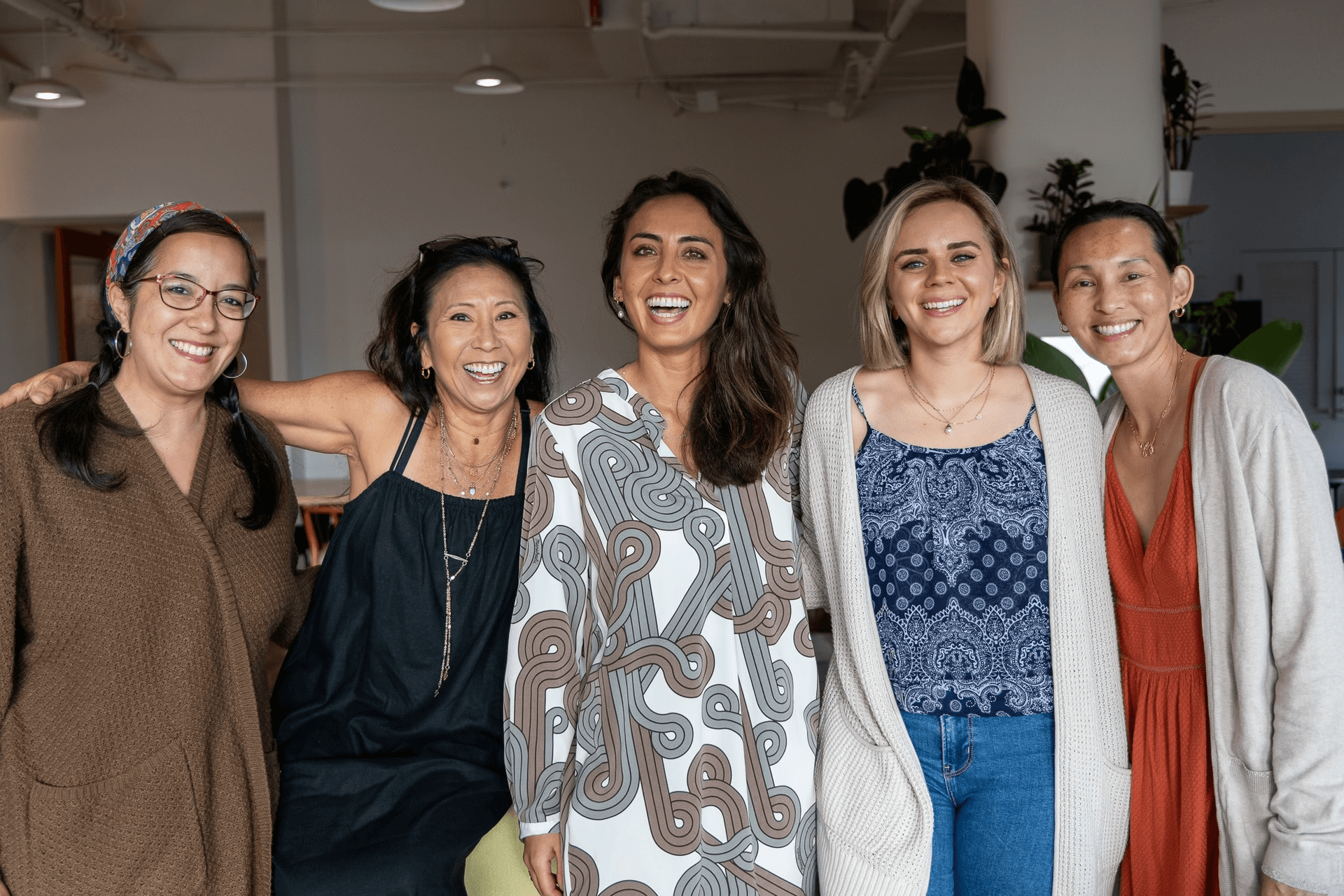 five women smiling at a women's empowerment workshop