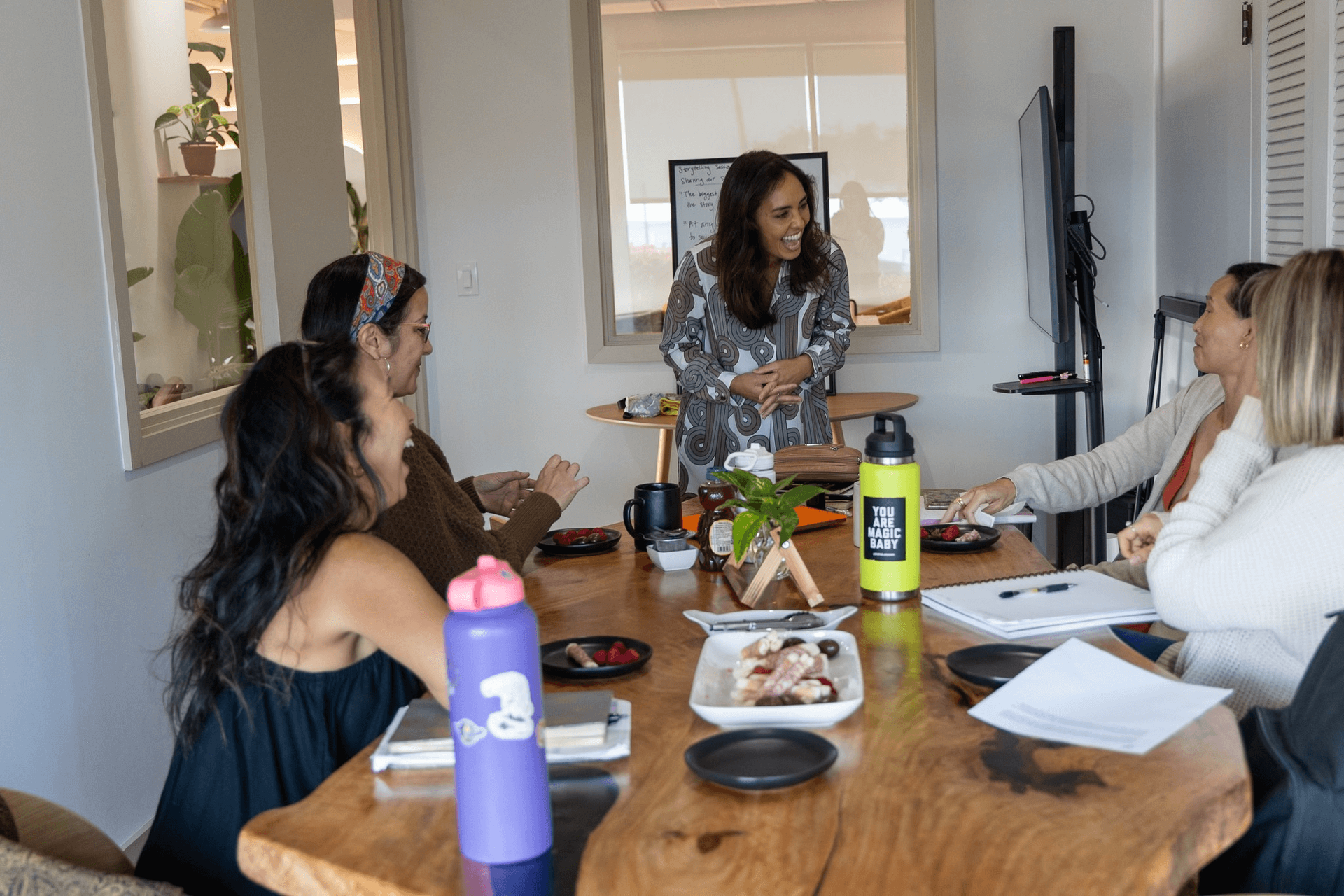 group of women smiling and laughing together in a personal development workshop on Oahu