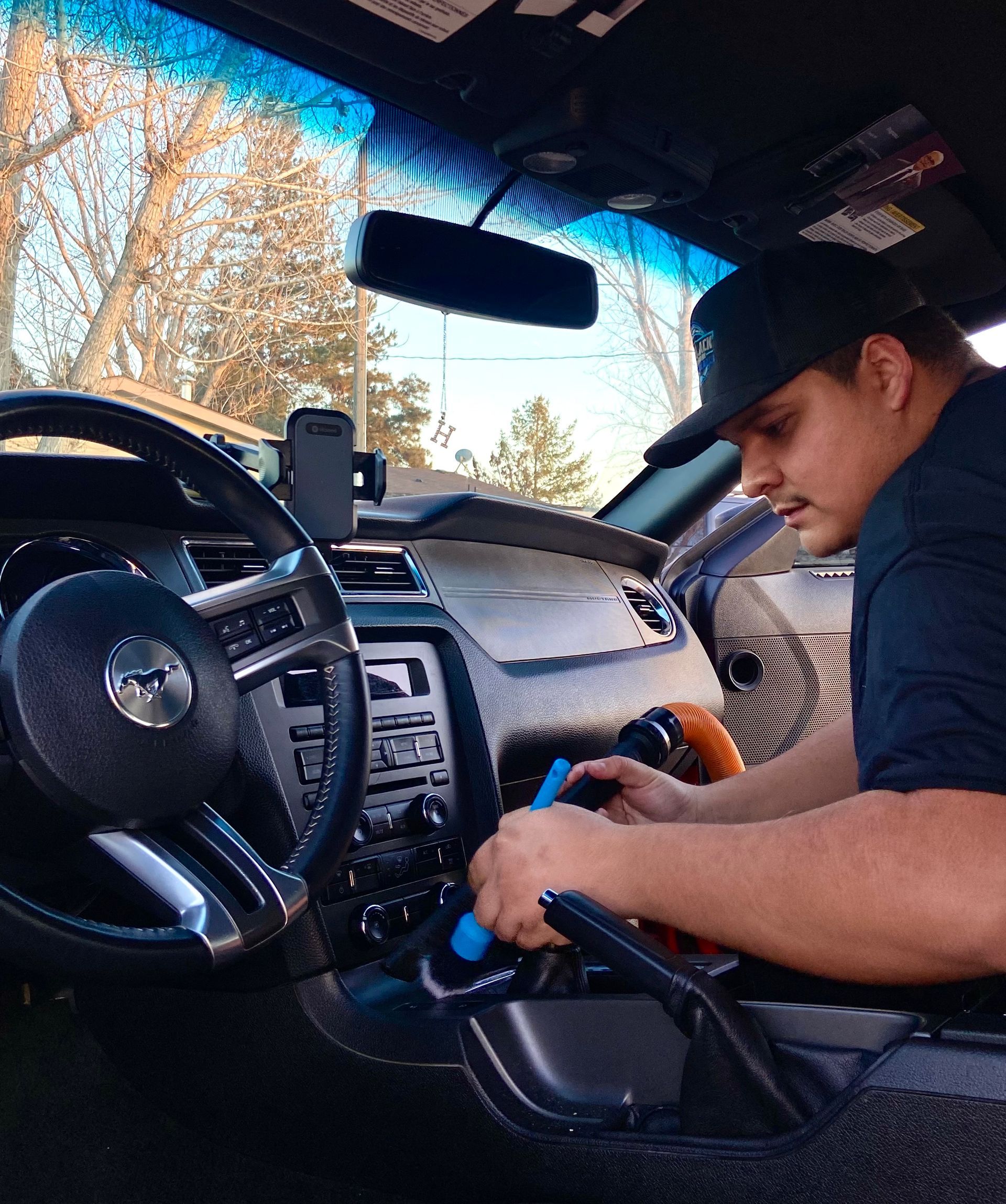 A man is working on the dashboard of a car