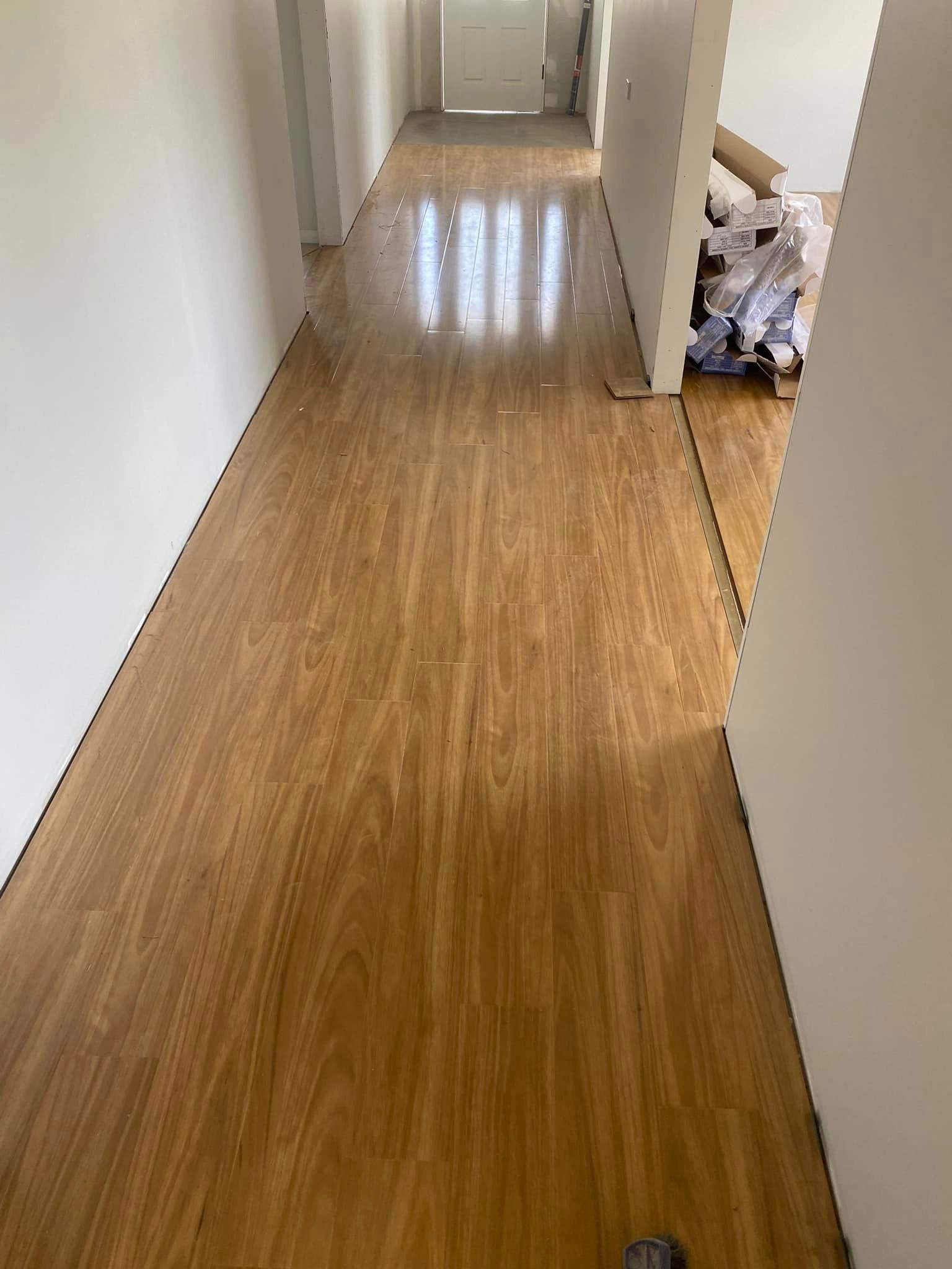 A Hallway With A Wooden Floor And White Walls —  Cabonne Carpets In Molong, NSW