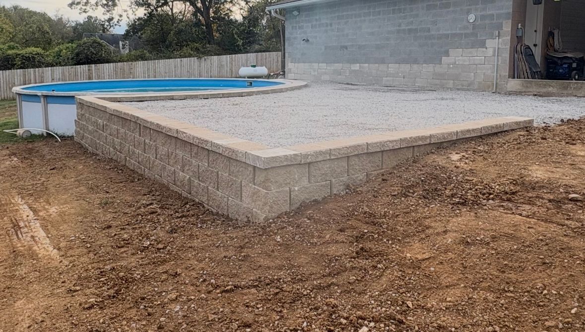 A brick house with a lush green lawn in front of it.