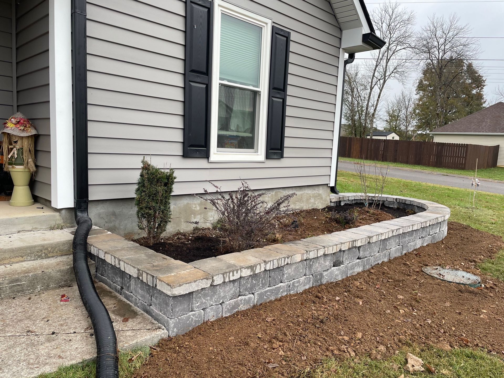 A house with a planter in front of it.