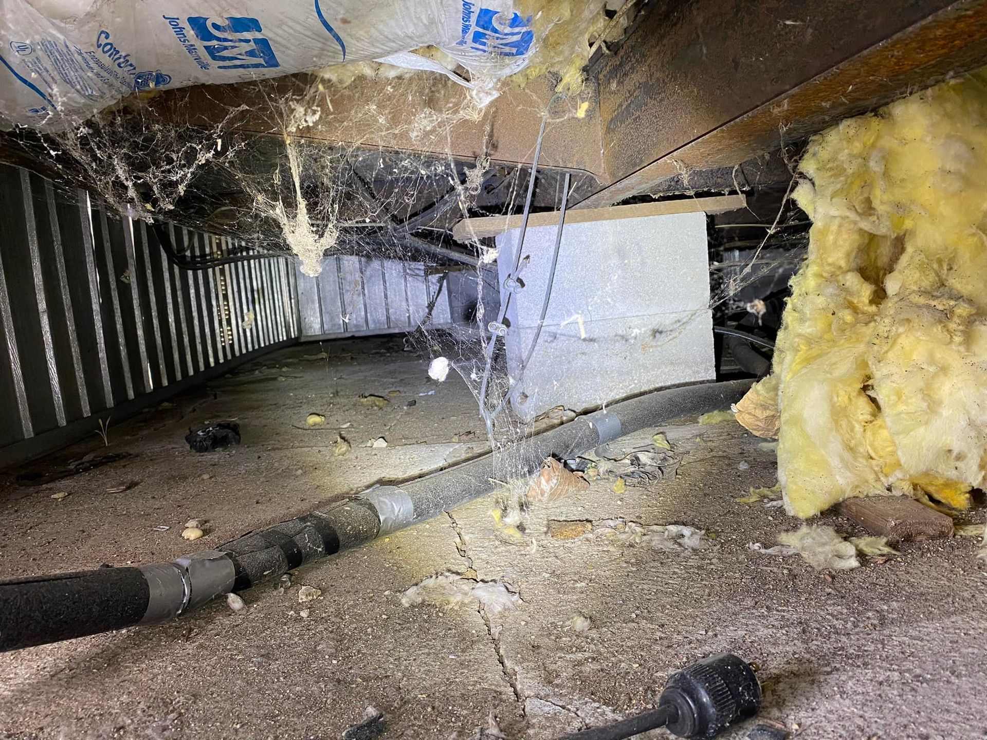 There is a lot of insulation in the attic of a house.