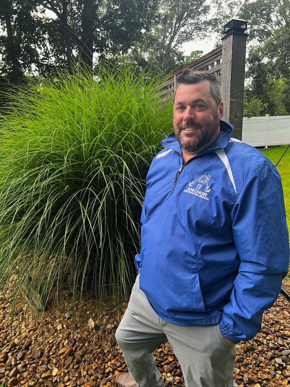 A man in a blue shirt is smiling for the camera.