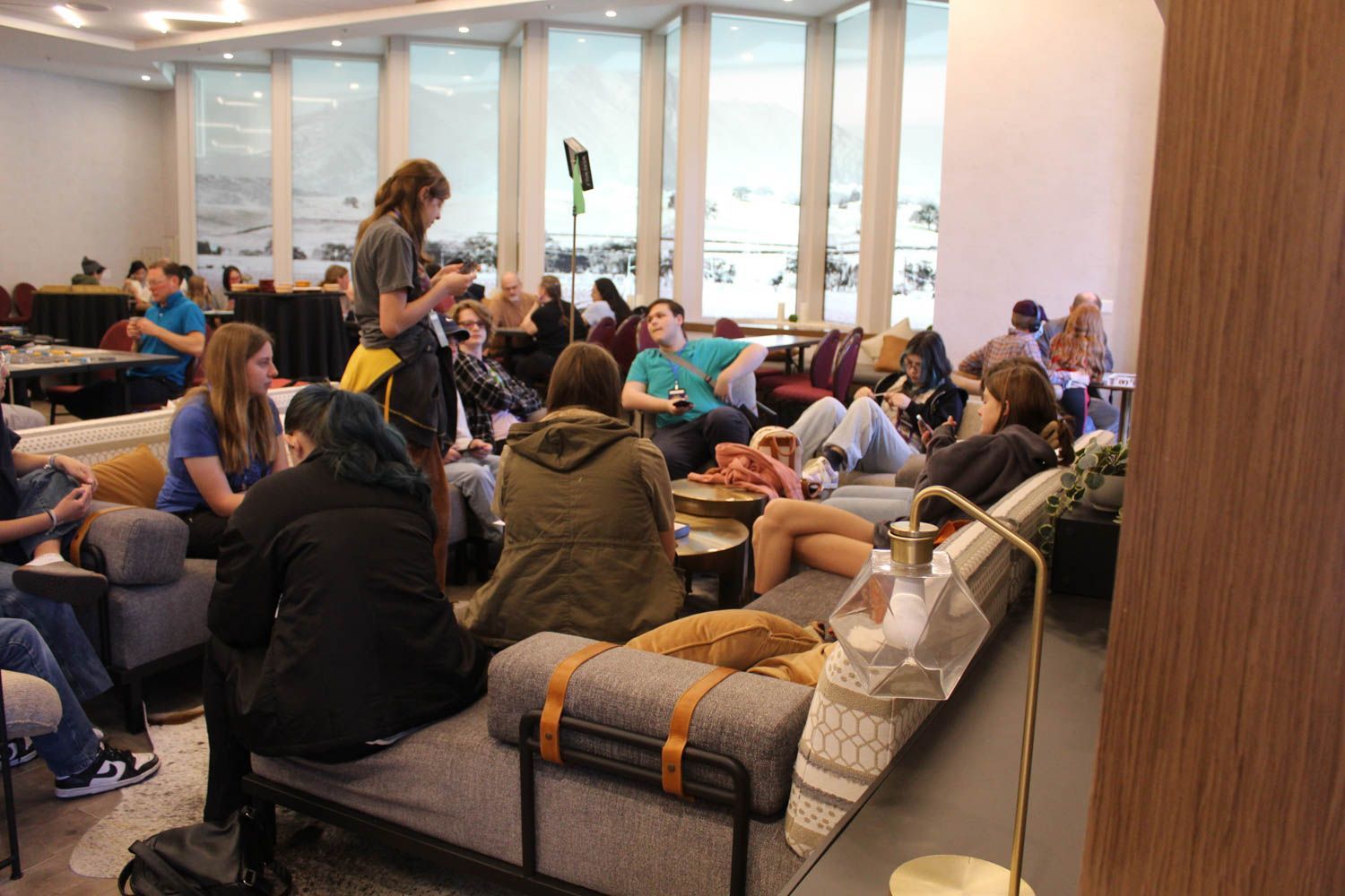 A group of people are sitting on couches in a room.