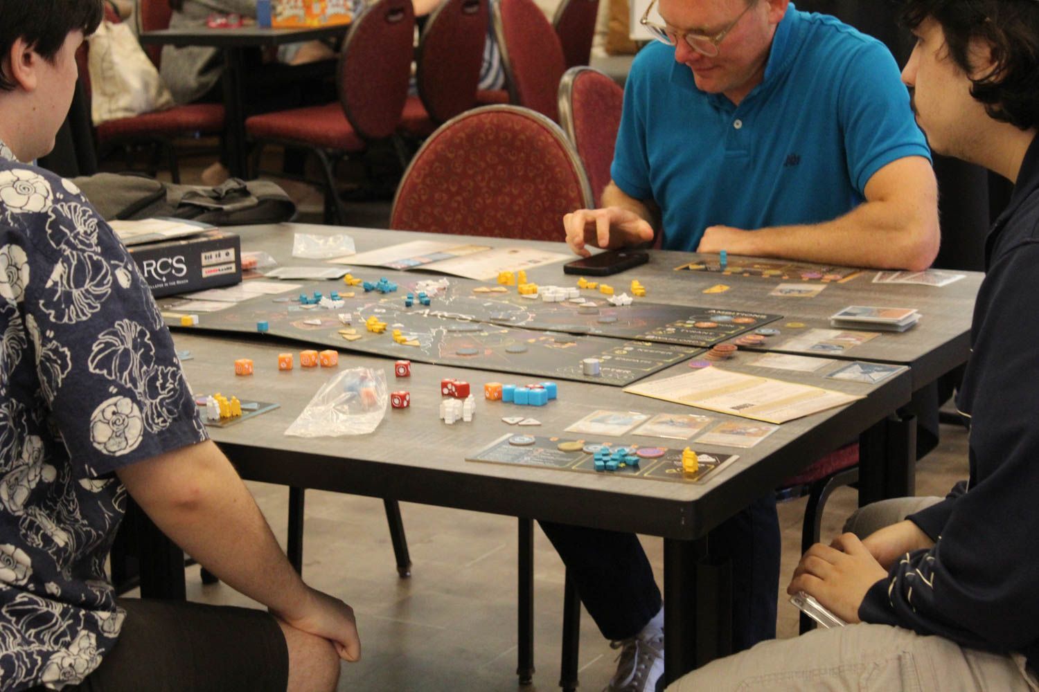 A family playing a game at GameSchoolCon in Irvine, CA.