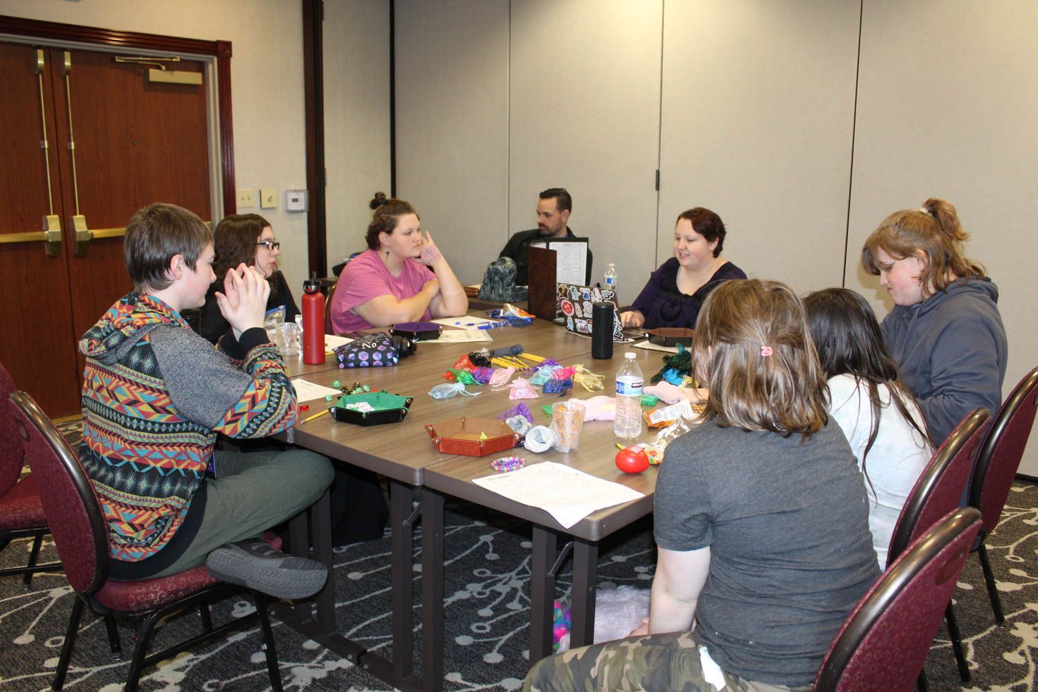 A group of mixed aged attendees plaing a TTRPG at GameSchoolCon in Irvine, CA.