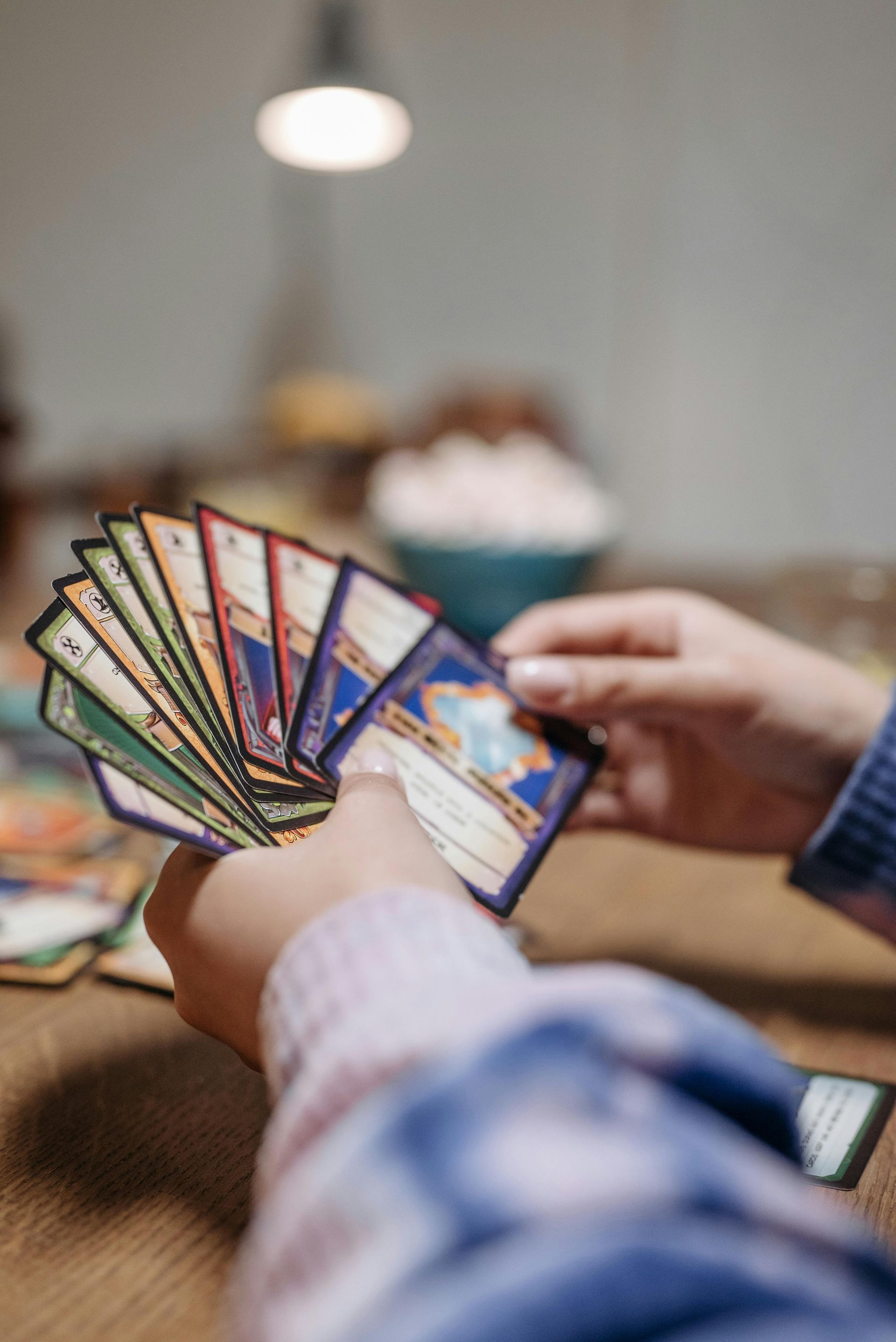 A person is holding a fan of cards in their hands.
