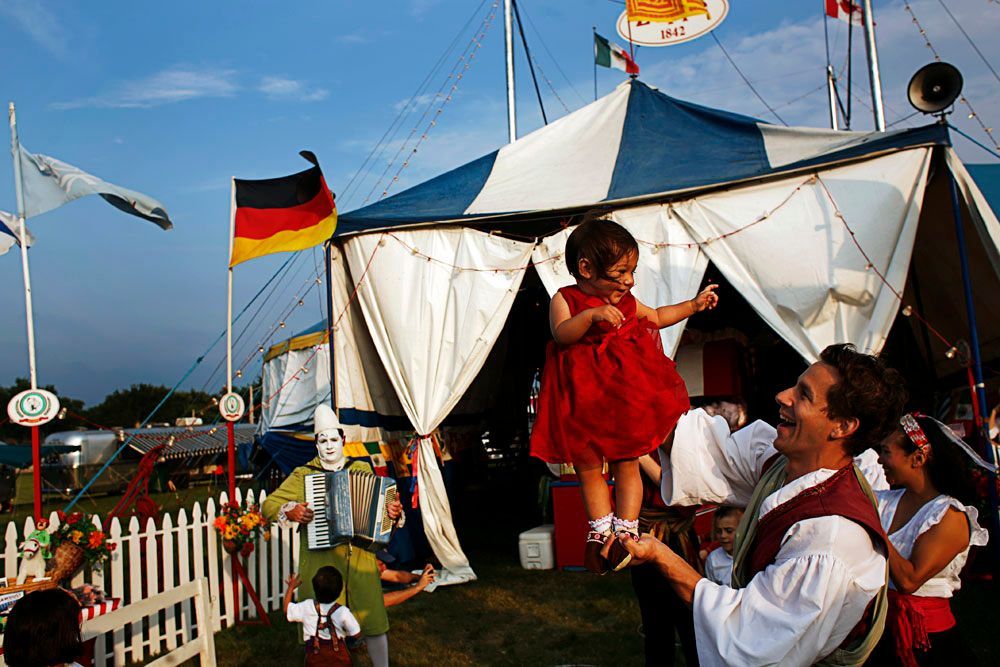 Carlo Gentile holds Giulia, 1, in front of the tent at The Zoppé family circus in Addison, Illinois.