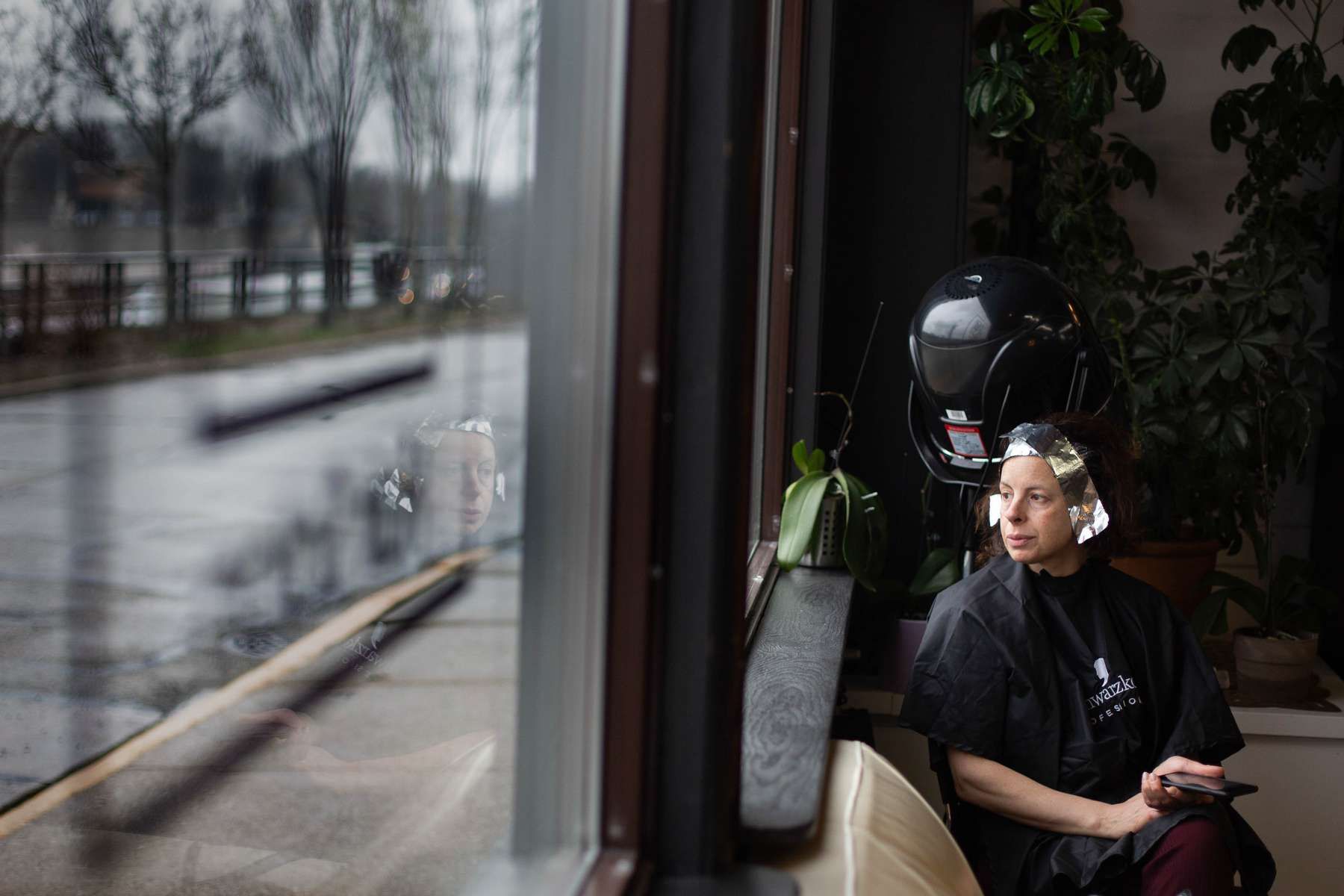 woman getting her hair dyed in a salon