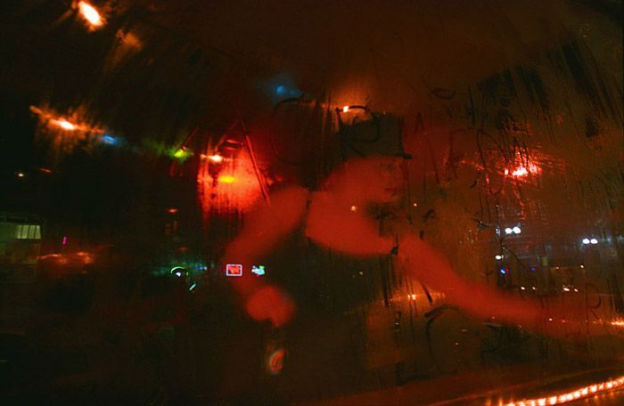 V Fox, a DJ for ACRN, writes ACRN Rocks  in the condensation on the window of Casa at $2 Prom on April 30, 2004. 'I think a lot of times I'd like to pretend we're very different from other groups,' says Liz Kozup 'But that's a little pretentious and kind of naïve to think that. People are really the same all over.'