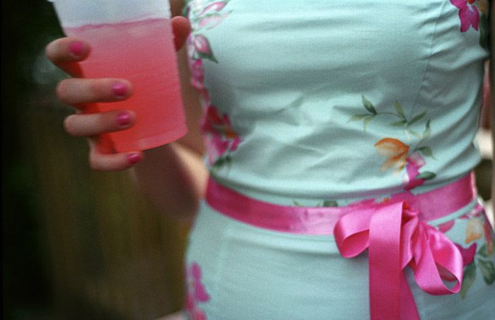 A sorority girl holds a drink at Date Party at the Theta Chi house. 'There's definitely a fraternity look. You can really tell at OU who's a fraternity guy or a sorority girl and who's artsy.' 