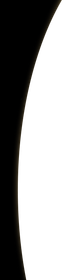 White, crescent-shaped object against a black background.