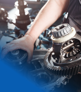 A close up of a person working on a gear | Motor Works