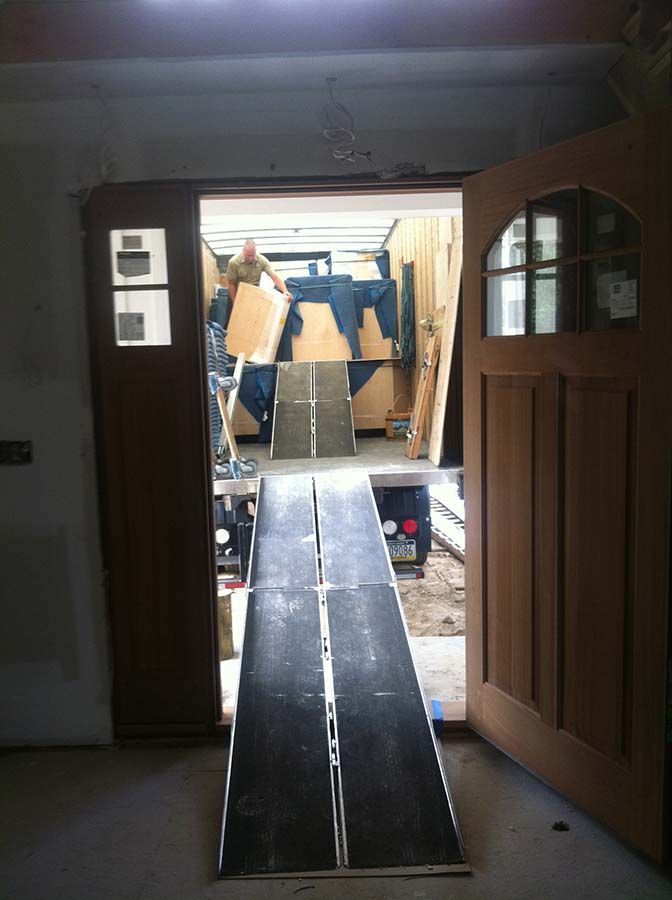 An open door with a ramp leading to a garage from Cupboard Wagon cabinet delivery services