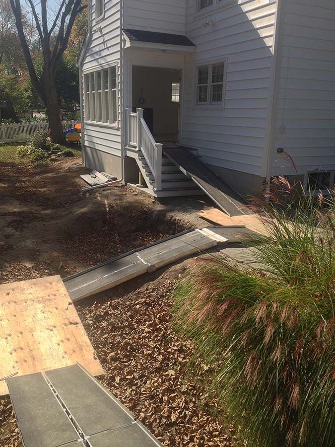 A white house with a ramp and stairs in front of it from Cupboard Wagon cabinet delivery services