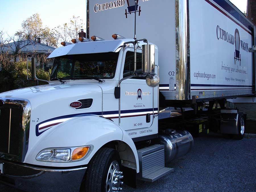 A white truck from Cupboard Wagon cabinet delivery services