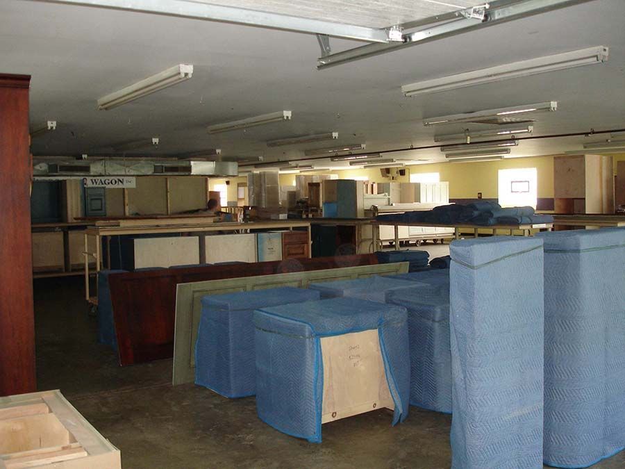 A large room filled with lots of furniture and boxes from Cupboard Wagon cabinet delivery services