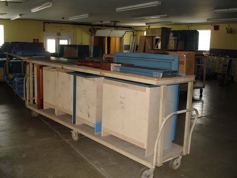 A cart in a room with boxes on it that says ' a ' on it from Cupboard Wagon cabinet delivery services