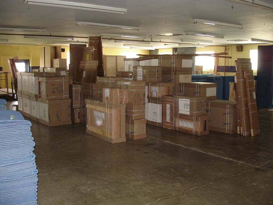 A large warehouse filled with lots of cardboard boxes from Cupboard Wagon cabinet delivery services