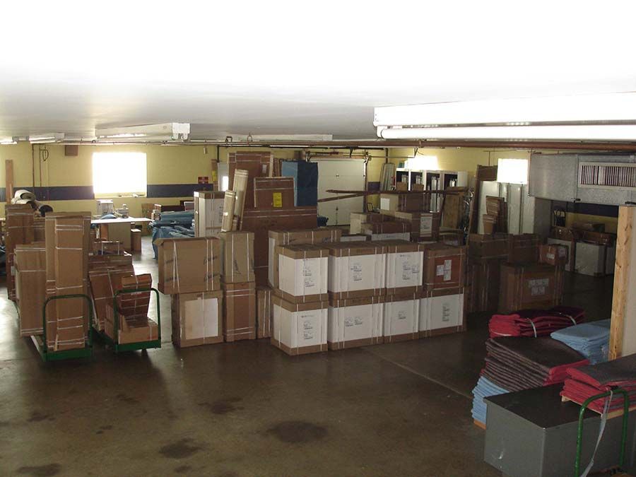 A large warehouse filled with lots of cardboard boxes from Cupboard Wagon cabinet delivery services