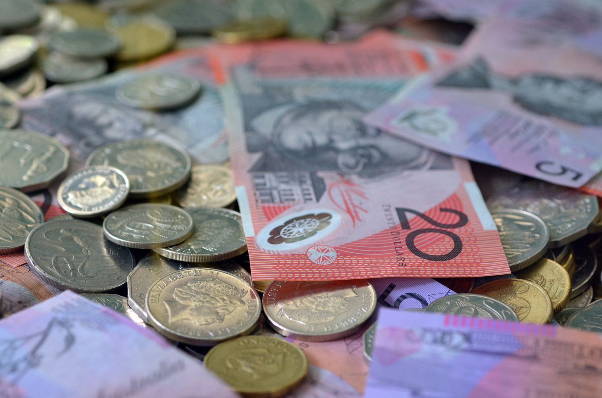 Australian currency: twenty-dollar bills and assorted coins scattered on a surface.