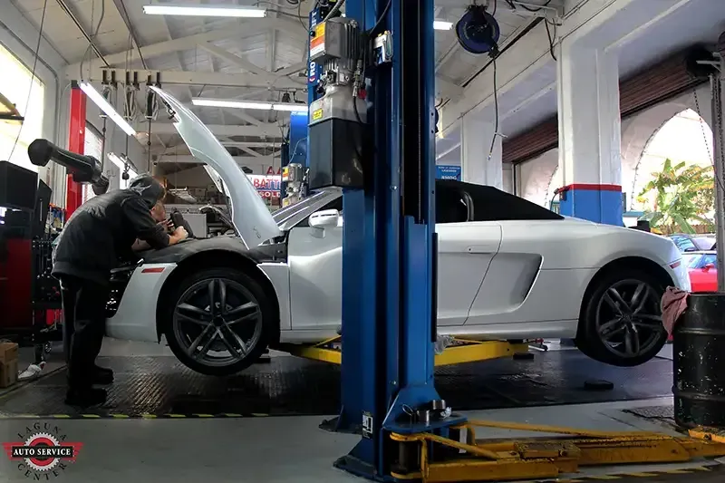 White Vehicle on a Lift at Laguna Auto Service Center