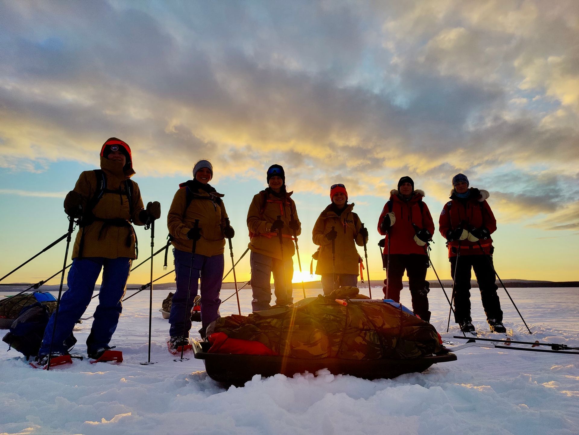 A snowy road with trees on both sides at night.
