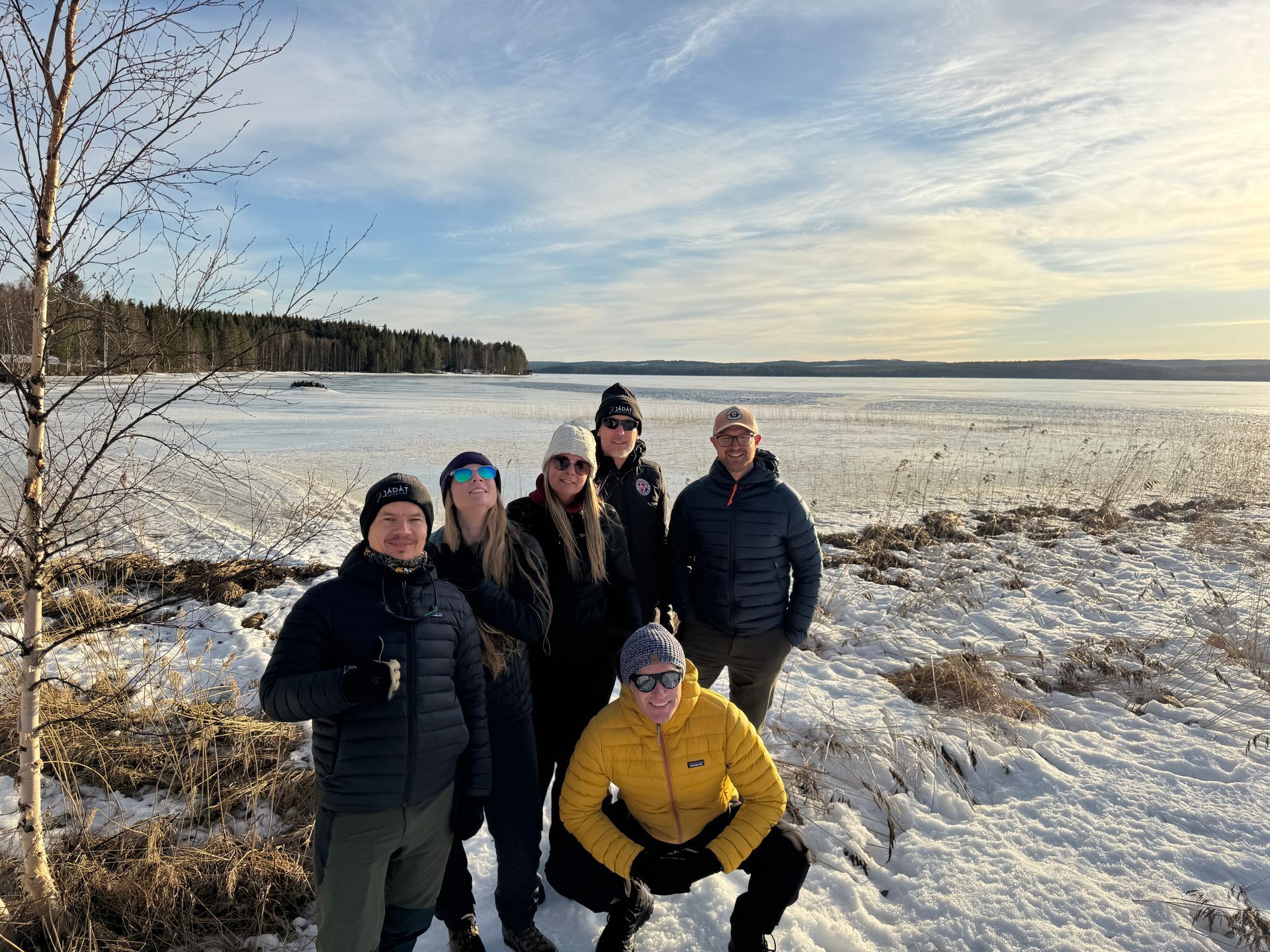 A snowy field with a red tent in the background