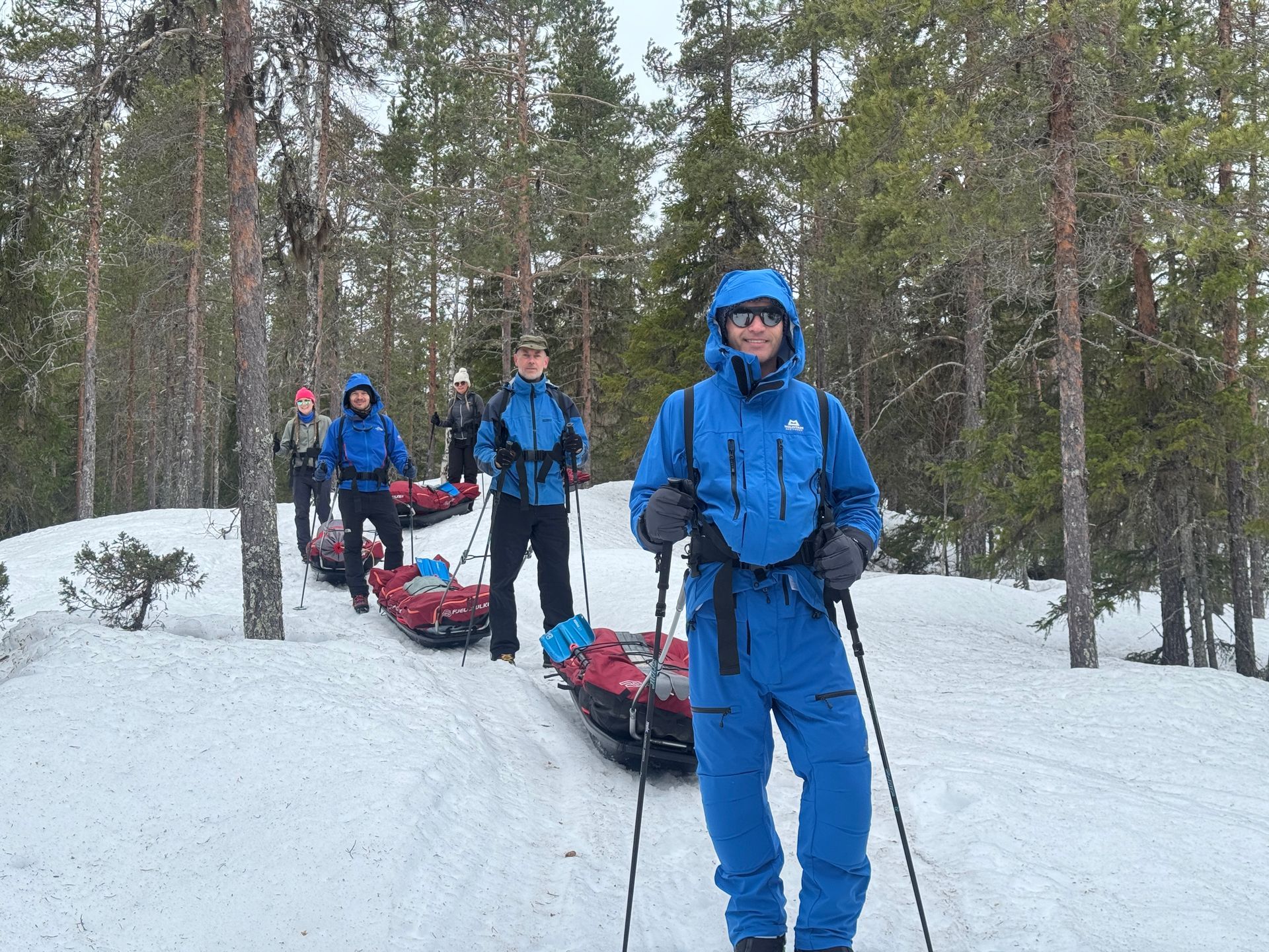 A snowy field with a red tent in the background