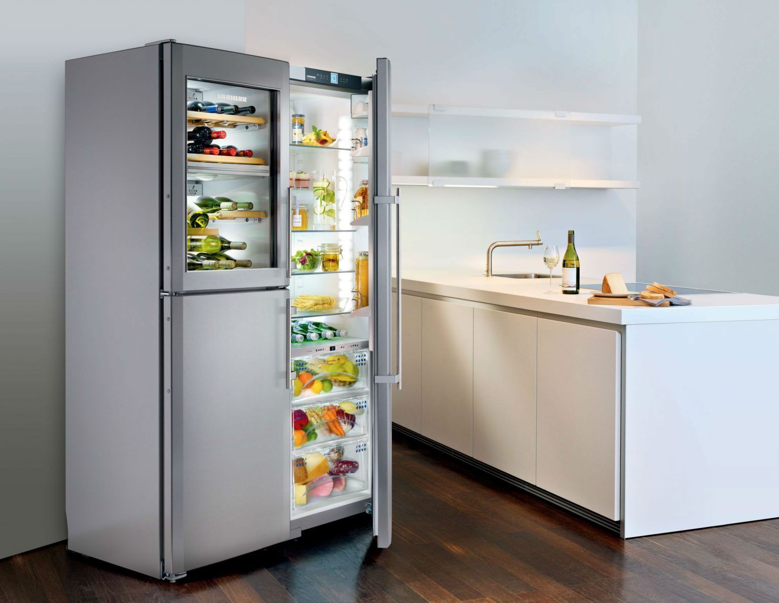 A stainless steel refrigerator in a kitchen with the door open