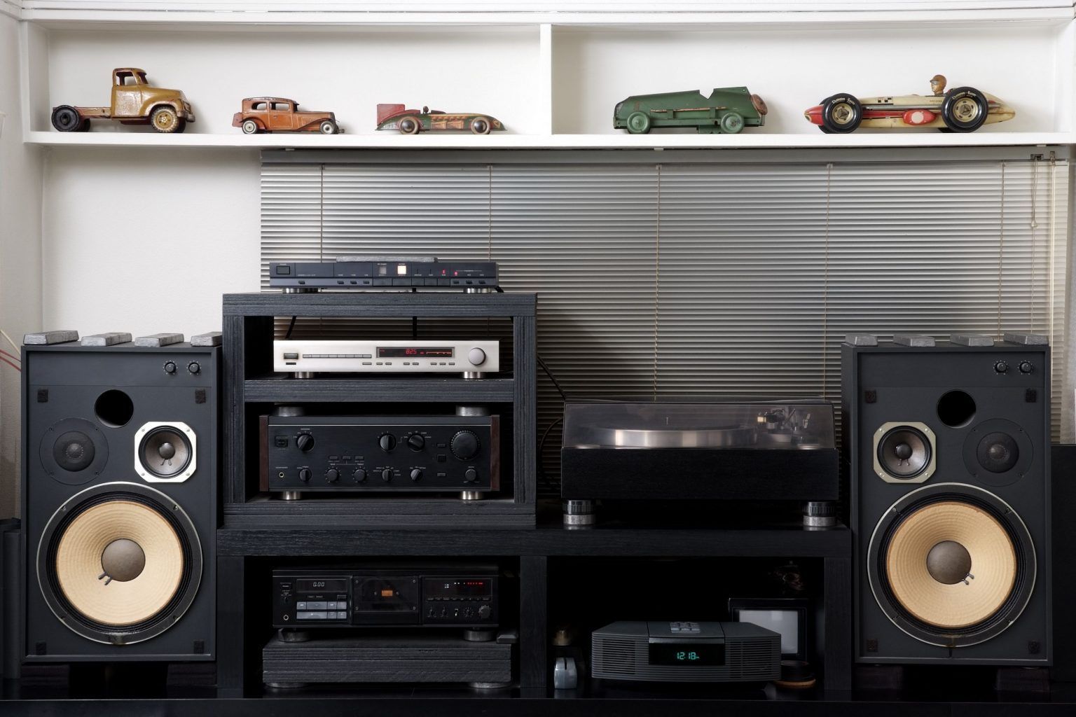 A room with a lot of electronics and speakers