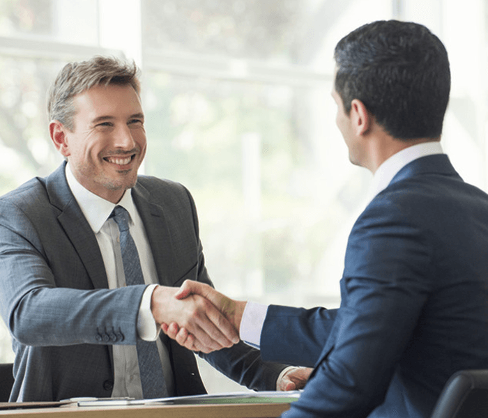 Businessmen shaking hands in meeting