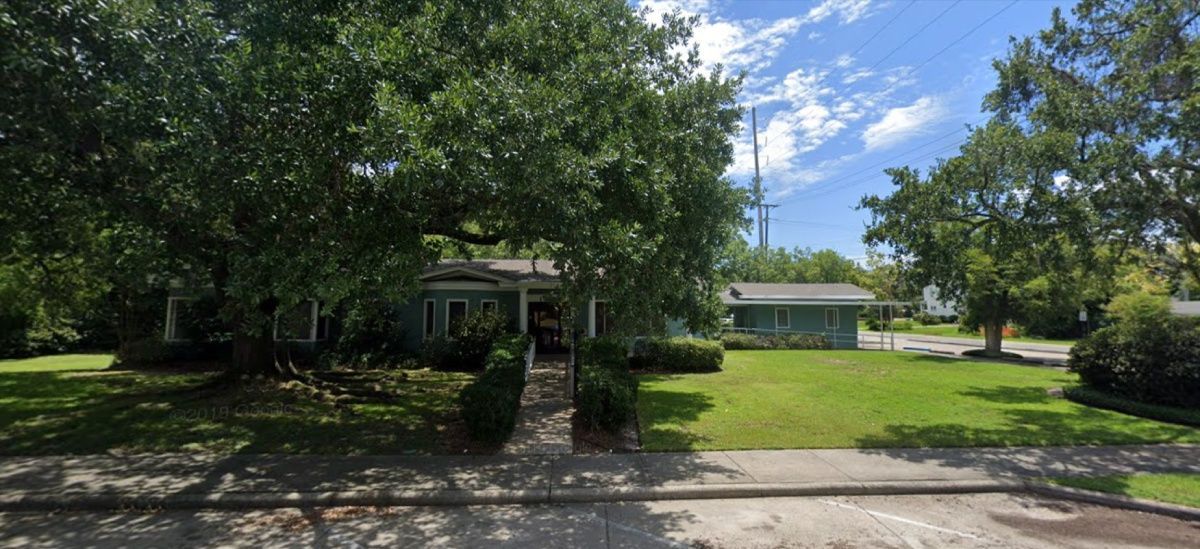 Portrait of relaxed fun senior couple wearing glasses on background
