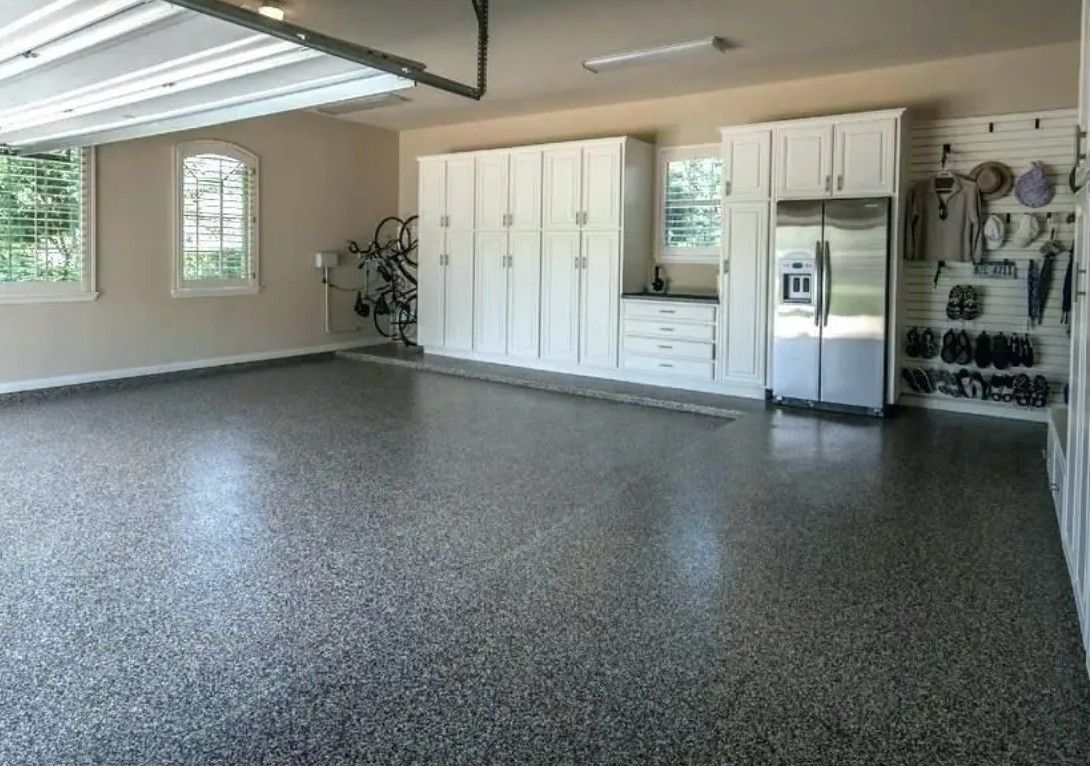 Spacious garage with speckled epoxy floor. 