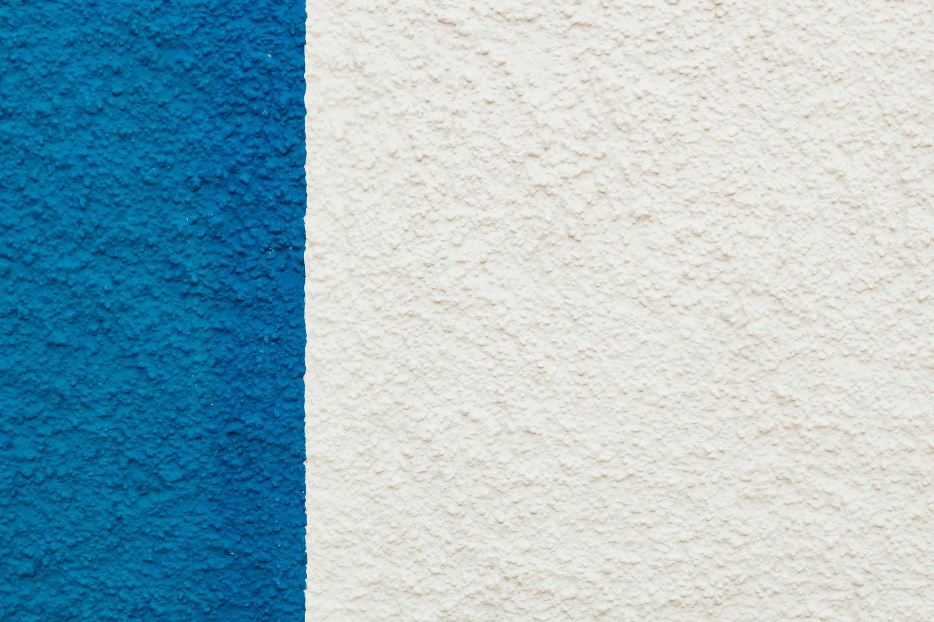 Blue vertical stripe next to a textured white surface.