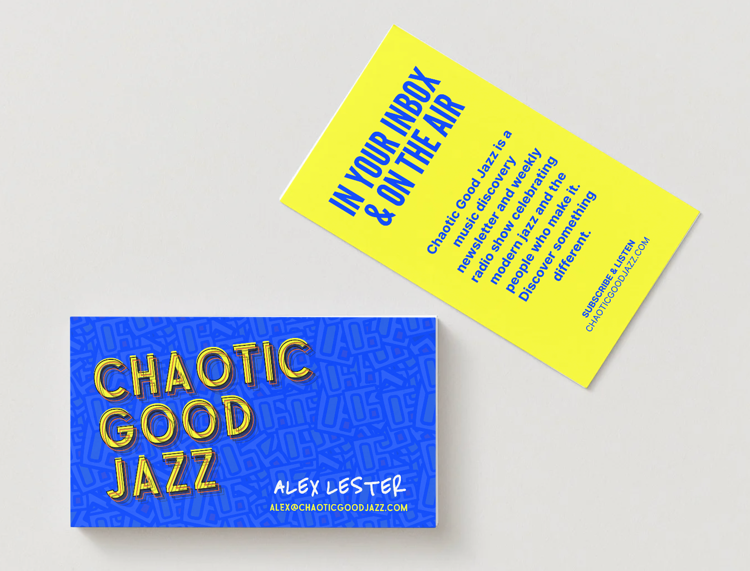 Person using a laptop, typing at a table near a window. Website visible on screen.